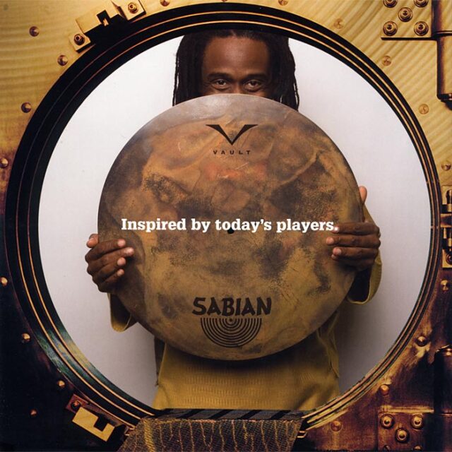 Advertisement of Will Calhoun holding a Sabian cymbal